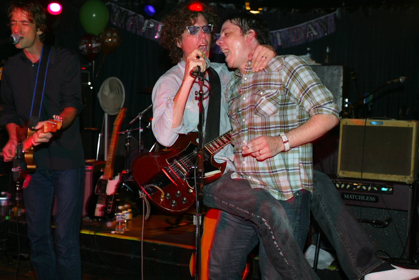 Gary Louris hopped got carried away, literally, by Jeff Tweedy as they sang backing vocals while Jim Boquist, left, sang lead on a Golden Smog number.