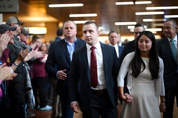 Minnesota state trooper Ryan Londregan is greeted by supporters as he arrives with his wife, Grace, and his legal team Monday, April 29, 2024, at the 