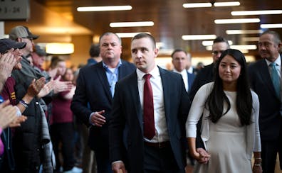 Minnesota state trooper Ryan Londregan is greeted by supporters as he arrives with his wife, Grace, and his legal team Monday, April 29, 2024, at the 