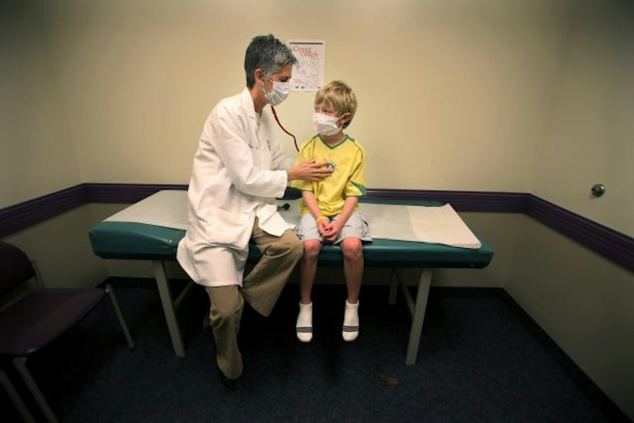 At Central Pediatrics, Dr. Shelly Strong checked on a 9-year-old patient recovering from H1N1 symptoms. The clinic is having patients with H1N1 symptoms wear masks as soon as they check in and clinic staff members are taking the same precaution.