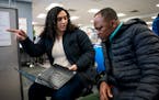 UPS talent recruiter Kiaira Fletcher-Toney helps Cephas Awudzi with his application at a job fair in Minneapolis earlier this month.