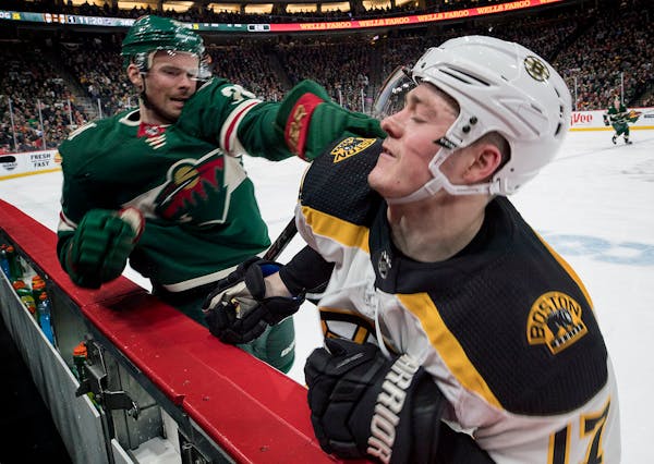Nate Prosser (36) and Ryan Donato (17) pushed off each other in front of the Wild bench in the third period.