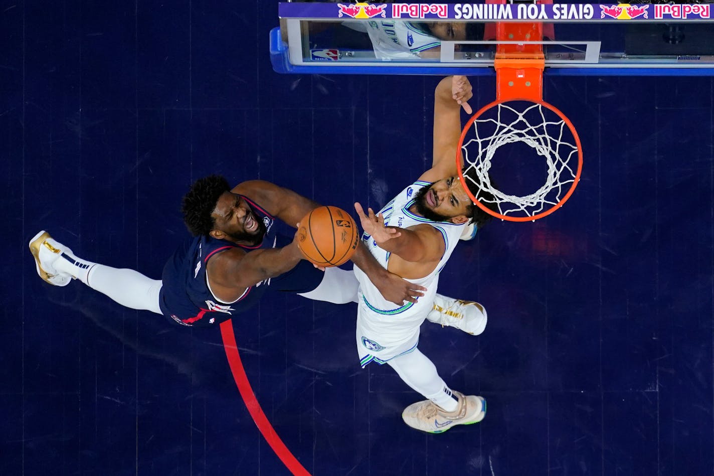 Philadelphia 76ers' Joel Embiid, left, goes up for a shot against Minnesota Timberwolves' Karl-Anthony Towns during the first half of an NBA basketball game, Wednesday, Dec. 20, 2023, in Philadelphia. (AP Photo/Matt Slocum)