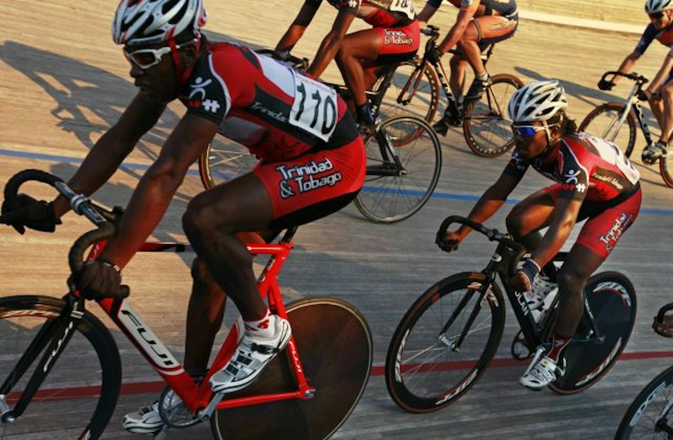 At the National Sports Center Velodrome, Trinidad and Tobego National Team members Joshua Alexander(110) and Rudy Ashton(104) race with local Minnesotans.