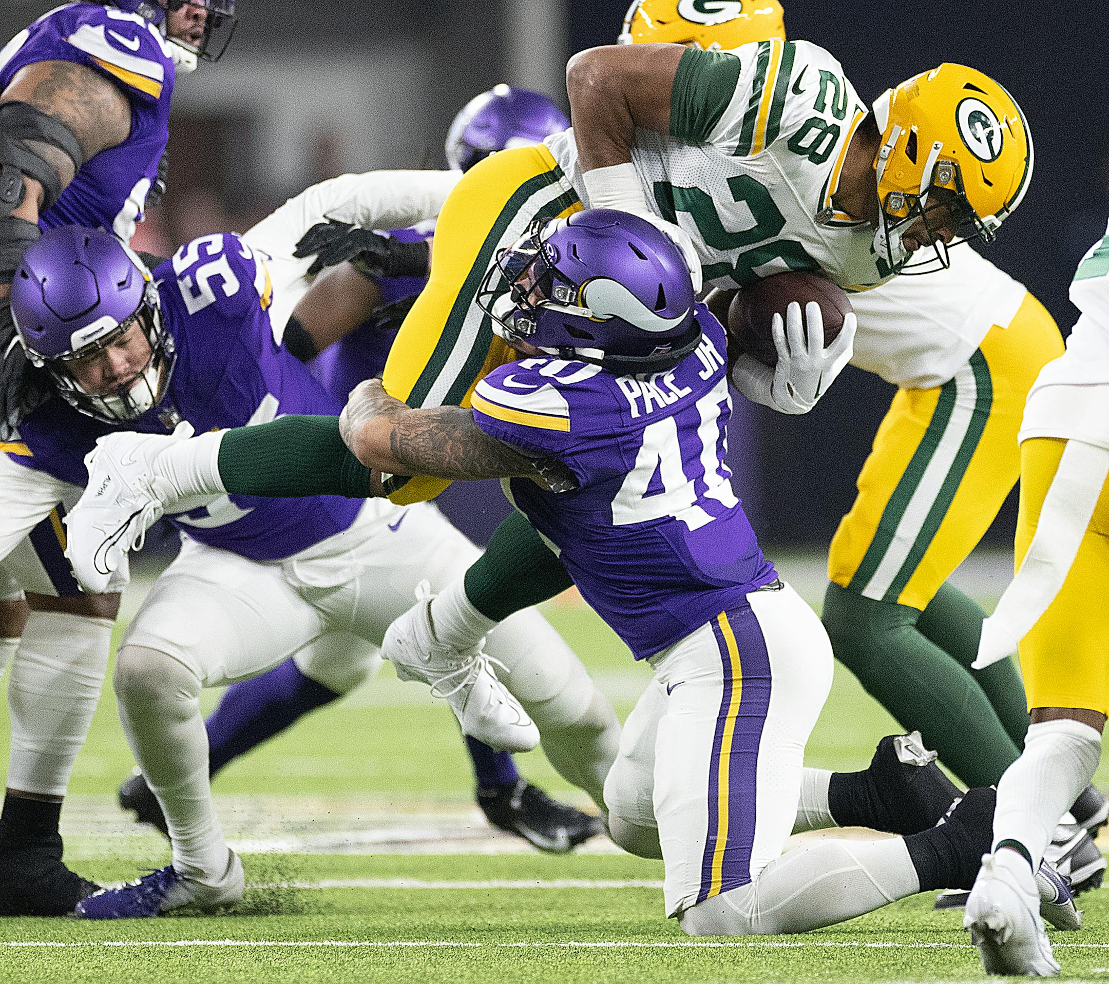 Vikings linebacker Ivan Pace Jr. (40) tackles Packers running back AJ Dillon (28)in the first quarter at U.S. Bank Stadium, in Minneapolis, Minn., on Sunday, Dec. 31, 2023. ] Elizabeth Flores • liz.flores@startribune.com