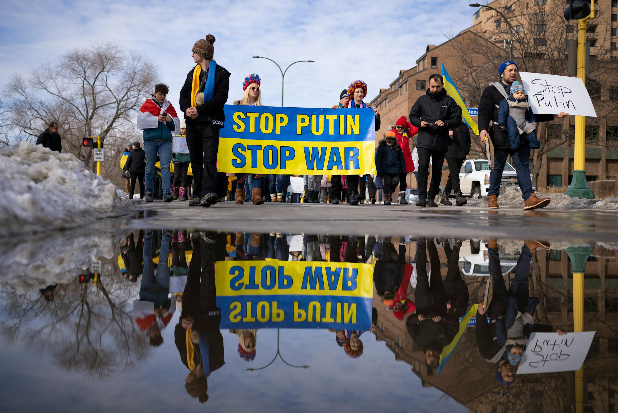 Marchers showing support for Ukraine walked on Main St. SE towards the Stone Arch Bridge Sunday afternoon, February 27, 2022 in Minneapolis, Minn. Hundreds of supporters of the people of Ukraine met a few dozen supporters of the Belarusian people midway across the Stone Arch Bridge in Minneapolis before continuing on a march together across the Hennepin Ave. bridge to Northeast Minneapolis where the march first began. ] JEFF WHEELER • Jeff.Wheeler@startribune.com