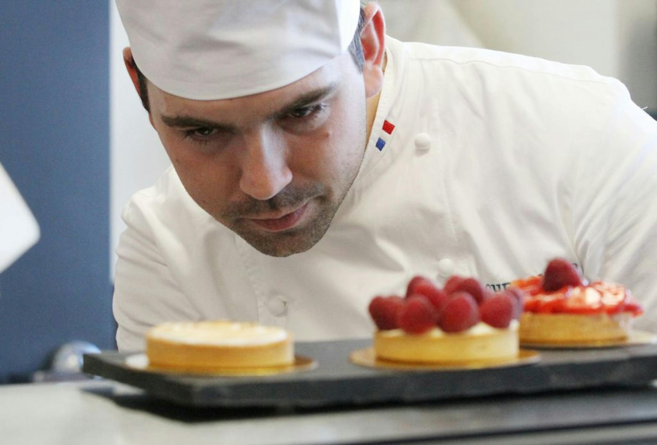 Arnaud de Rambures sized up a tray of fruit and lemon tarts at his family-run bakery in Maple Grove.