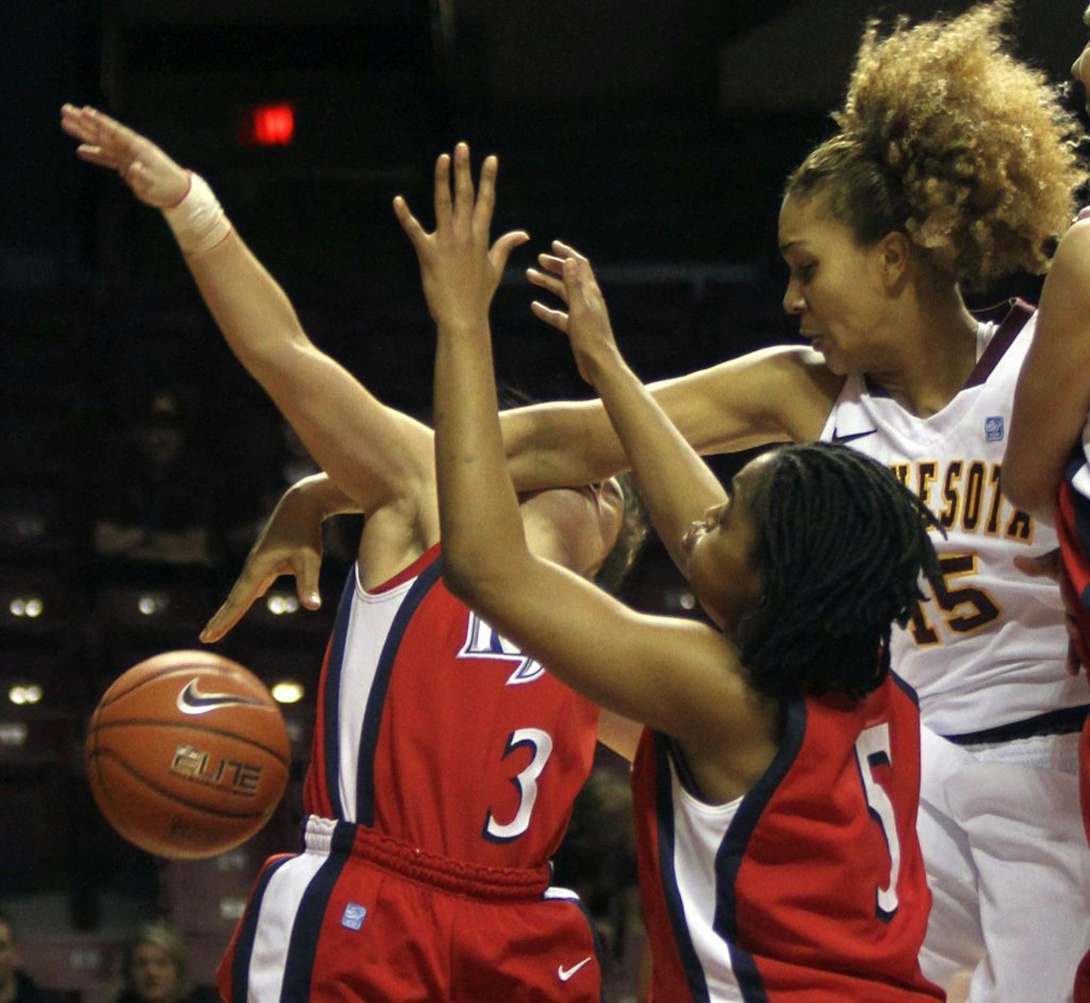Gopher Micaella Riche hit Highlander Alyssa Albanese across the face going after the ball causing a bloody nose during the first half at Williams Arena in Minneapolis Min., Friday, December 23, 2011.