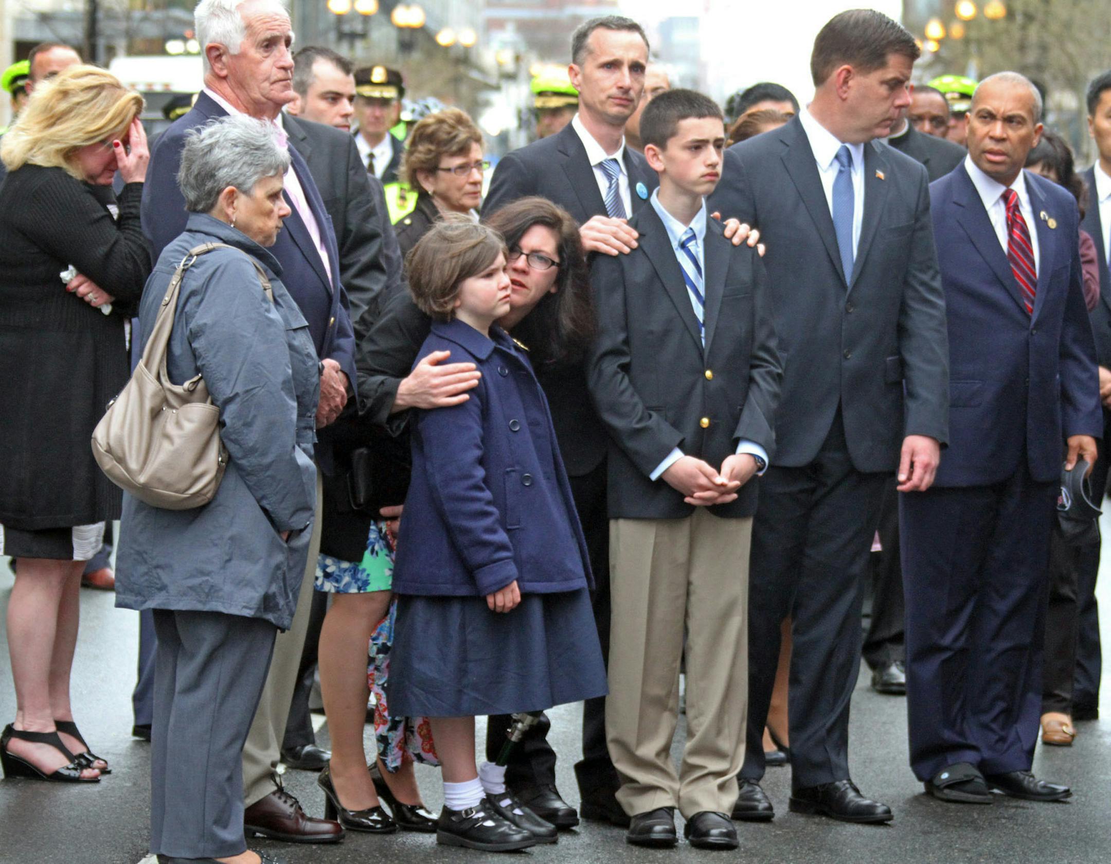 The Richard family along with Boston Mayor Marty Walsh and Massachusetts Gov. Deval Patrick participate in a wreath laying ceremony to commemorate the one year anniversary of the Boston Marathon bombings, Tuesday, April 15, 2014, in Boston. Martin Richard lost was killed in the bombing. (AP Photo/The Boston Herald, Nancy Lane) BOSTON GLOBE OUT; METRO BOSTON OUT; MAGS OUT; ONLINE OUT