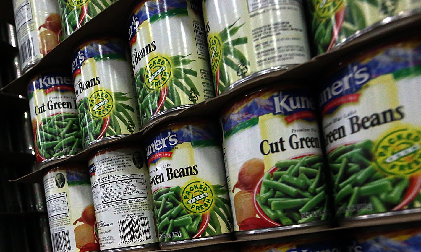 Full labeled cans stand at the end of the production line.