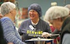 Several groups gathered at the workstation tables inside Feed My Starving Children in Coon Rapids on Give To The Max day. FMSC received an additional 