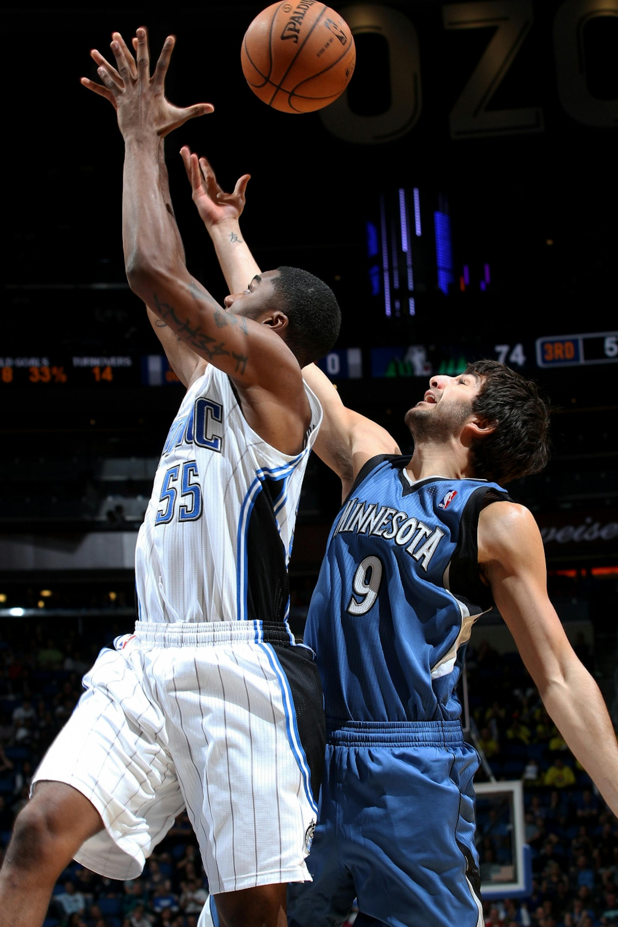 Magic guard E'Twaun Moore, left, fought for a rebound with Timberwolves guard Ricky Rubio during Orlando's 102-93 victory Monday. Rubio is not expected to play in Tuesday's game against Miami.