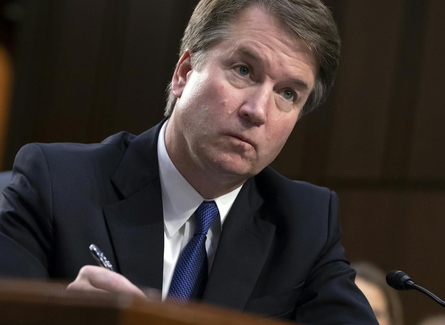 President Donald Trump's Supreme Court nominee, Brett Kavanaugh, takes notes as the Senate Judiciary Committee members make opening statements during his confirmation hearing, on Capitol Hill in Washington, Tuesday, Sept. 4, 2018. (AP Photo/J. Scott Applewhite)