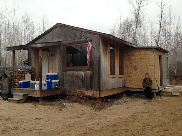 First-time deer hunter Connor Pennings, age 10, stands proudly next to his family’s newly constructed hunting shack.