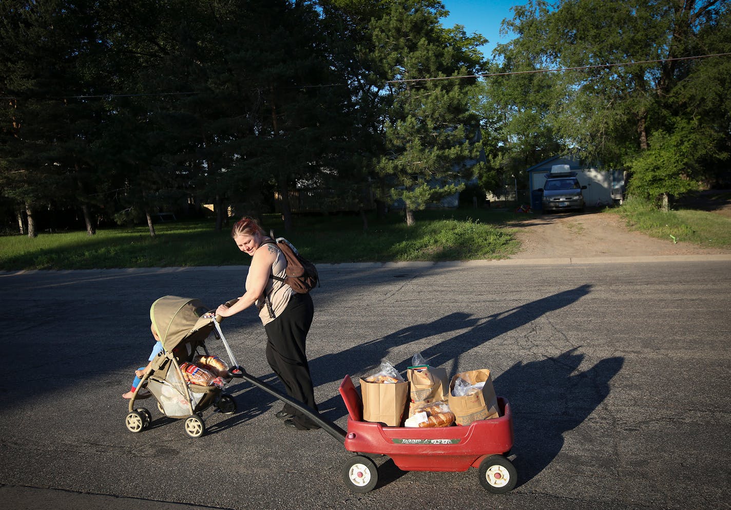 Tara Nordgren, who works at Burger King, walked home while pushing her son in the stroller after going to an Anoka food shelf.