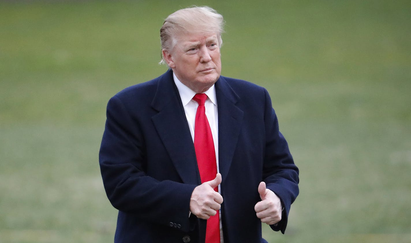 President Donald Trump give two thumbs up to guests after stepping off Marine One on the South Lawn of the White House, Sunday, March 24, 2019, in Washington. The Justice Department said Sunday that special counsel Robert Mueller's investigation did not find evidence that President Donald Trump's campaign "conspired or coordinated" with Russia to influence the 2016 presidential election. (AP Photo/Pablo Martinez Monsivais)