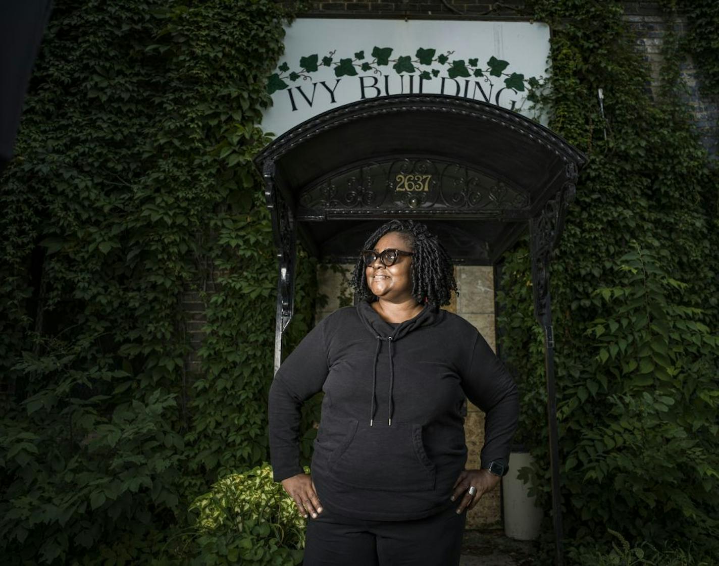 Therapist Felicia Sy poses in front of the Ivy Building, where she can't use her office because riots made the building uninhabitable for now.