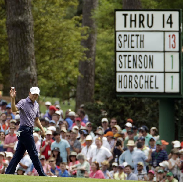 Jordan Spieth holds up his ball after a birdie on the 15th hole during the second round of the Masters golf tournament Friday, April 10, 2015, in Augu
