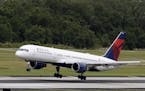 FILE - In this Thursday, May 15, 2014, file photo, a Delta Air Lines Boeing 757-232 lands at the Tampa International Airport in Tampa, Fla. Southwest 