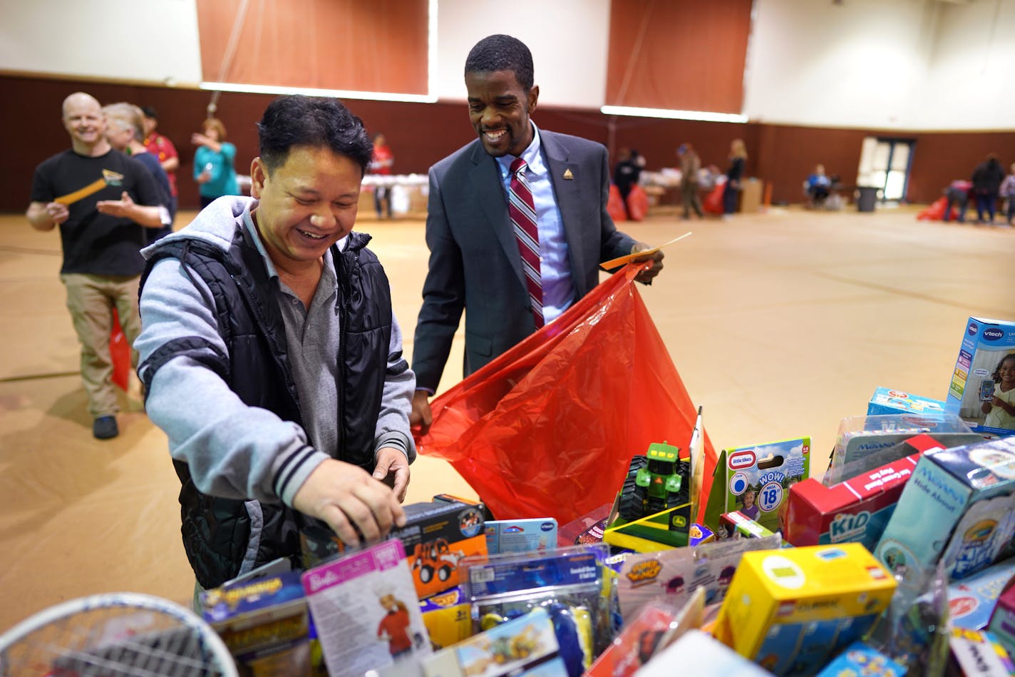 St. Paul Mayor Melvin Carter stopped in at the Salvation Army toy shop in St. Paul on Monday, Dec. 23, and helped shopper John Yang pick out toys for his 4 children ages 3, 4, 7 and 8.