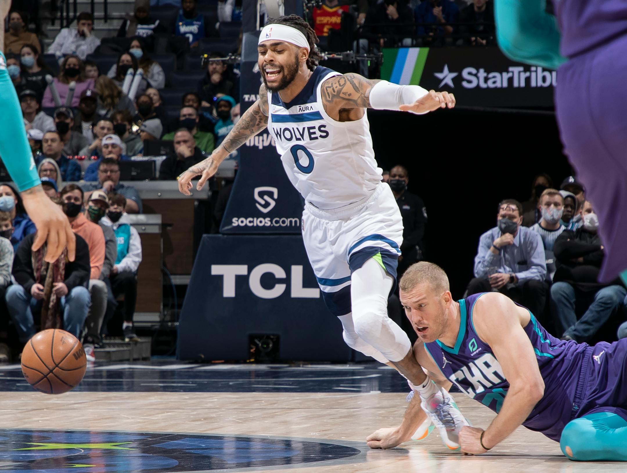 D'Angelo Russell (0) of the Minnesota Timberwolves is tripped up by Mason Plumlee (24) of the Charlotte Hornets in the second quarter.