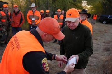 Minnesota Gov. Tim Walz gets his hunting license ceremoniously inspected before heading out for the annual Minnesota Governor's Pheasant Hunting Opene