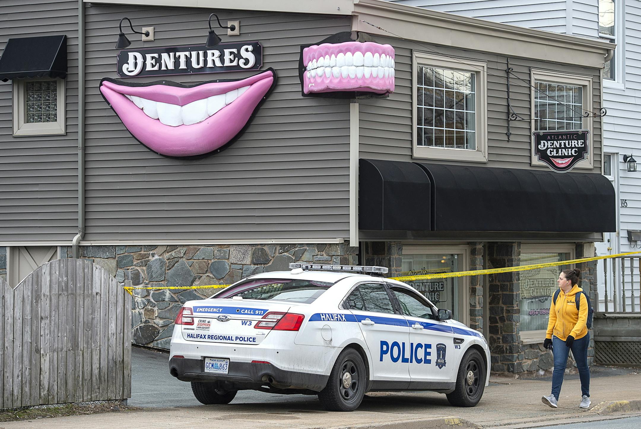 The Atlantic Denture Clinic, owned by Gabriel Wortman, is guarded by police in Dartmouth, Nova Scotia, on Monday, April 20, 2020. Wortman, a gunman disguised as a police officer went on a 12-hour rampage in the Canadian province beginning late Saturday, shooting people in their homes, setting fires and killing multiple people, including a policewoman, in the deadliest such attack in the country’s history. (Andrew Vaughan/The Canadian Press via AP)