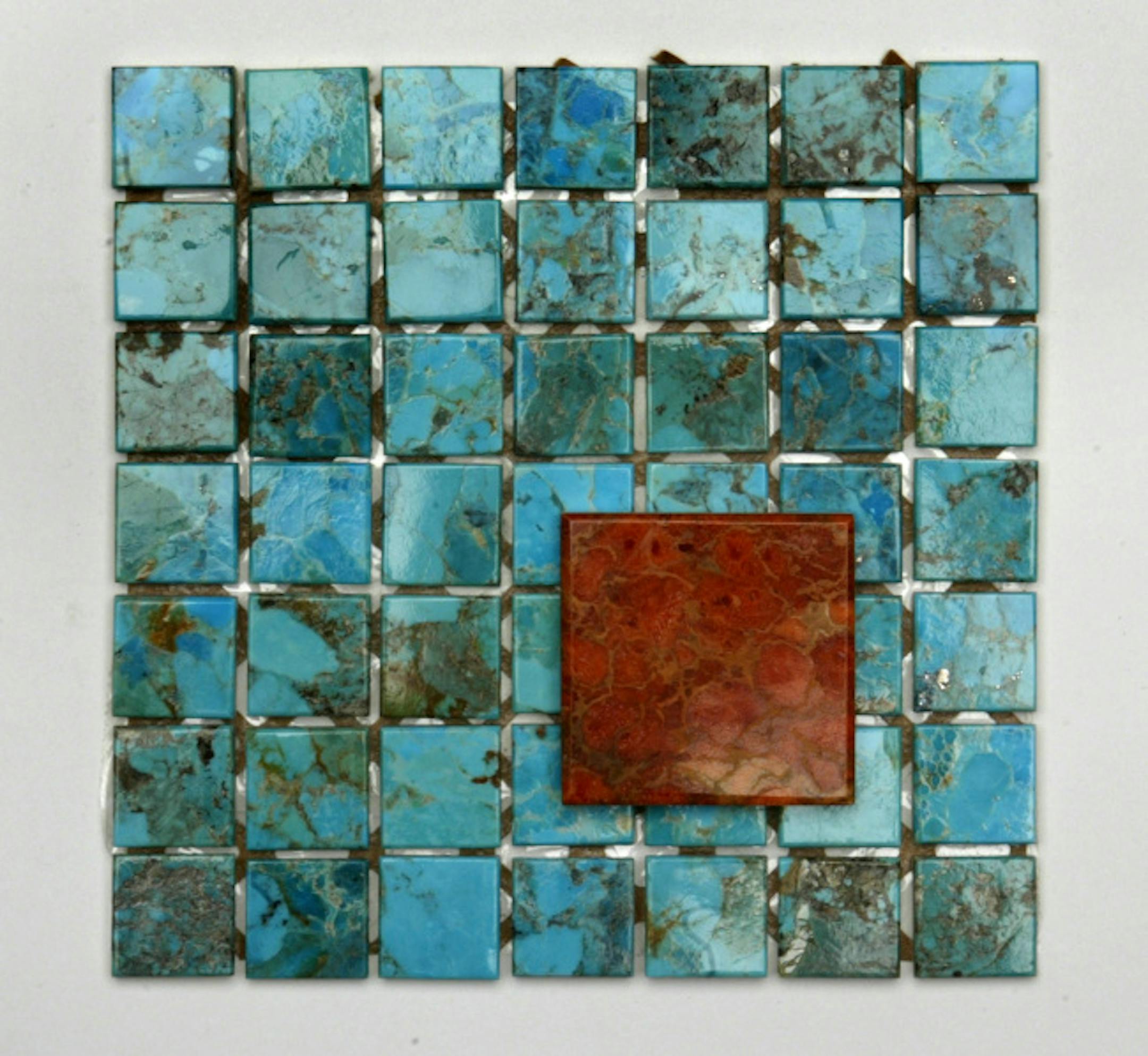 Jewelry-grade polished turquoise and coral are among the materials in Ann Sacks' new "Asteria" line of wall and accent tiles.