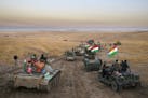 A Peshmerga convoy drives towards a frontline in Khazer, about 30 kilometers (19 miles) east of Mosul, Iraq, Monday, Oct. 17, 2016. The Iraqi military