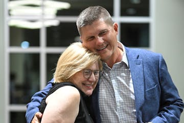 Republican U.S. Reps. Michelle Fischbach and Brad Finstad hugging.