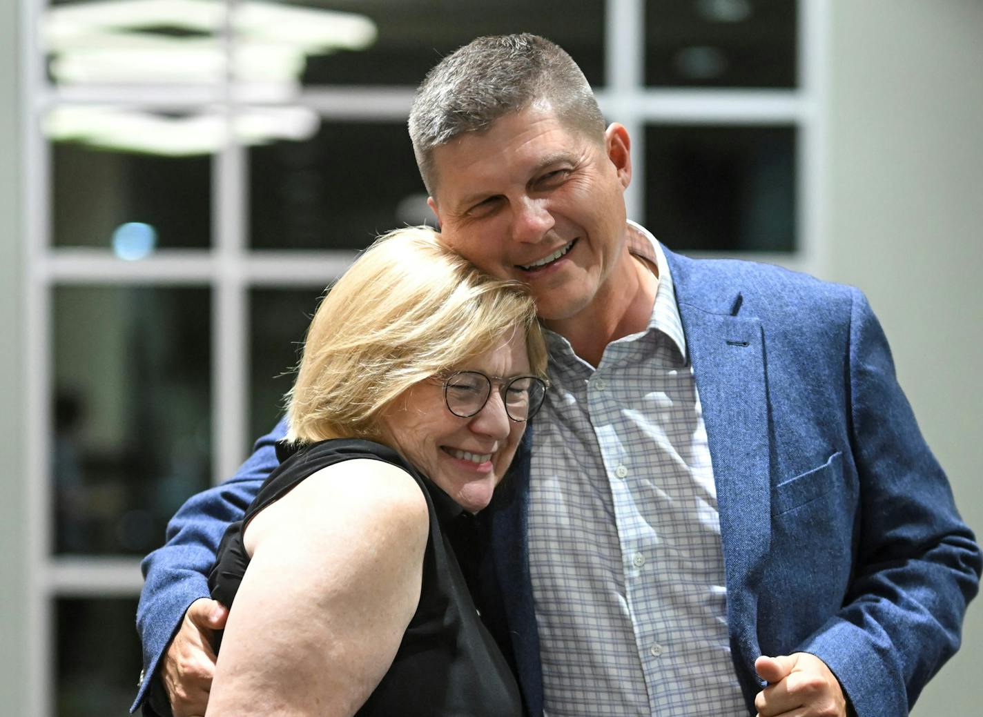 Republican U.S. Reps. Michelle Fischbach and Brad Finstad hugging.