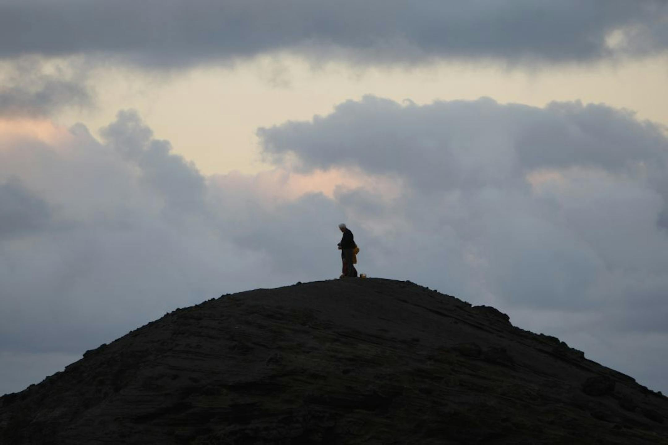 In this June 1, 2015 photo, a man watches as Yasur volcano erupts on Tanna Island in Vanuatu.