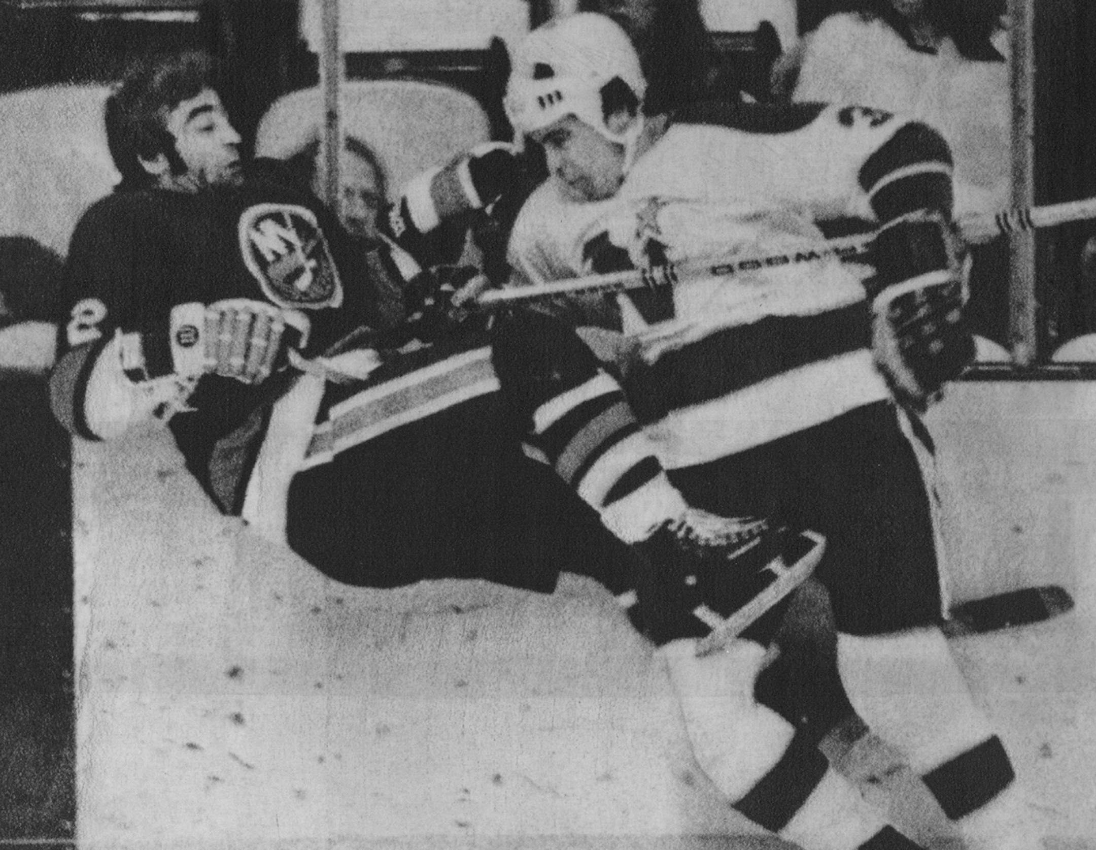 J.P. Parise was traded to the Islanders in 1975. He was upended by former teammate Fred Barrett when the teams played each other.