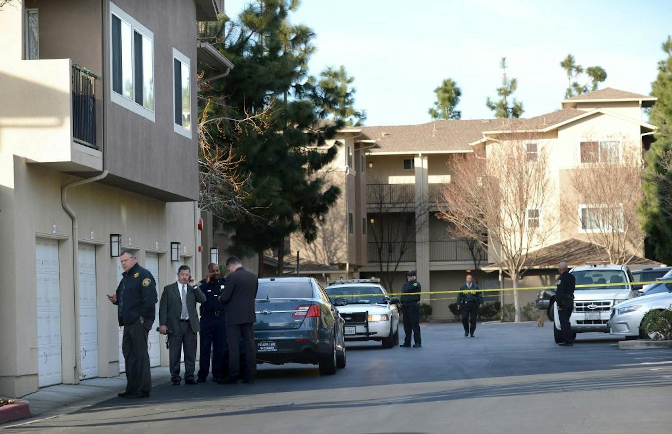 Law enforcement officers investigate the accidental fatal shooting of a Bay Area Rapid Transit police officer by a fellow BART officer while serving a warrant at an apartment building, according to officials, Tuesday, Jan. 21, 2014, in Dublin, Calif.