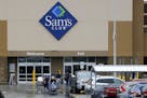 File- This Feb. 23, 2018, file photo shows shoppers leaving a Sam's Club in Pittsburgh. Walmart's Sam's Club is teaming up with several health care co