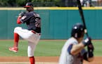 Cleveland Indians starting pitcher Corey Kluber delivers against Minnesota Twins' Brian Dozier in the first inning of a baseball game, Saturday, June 