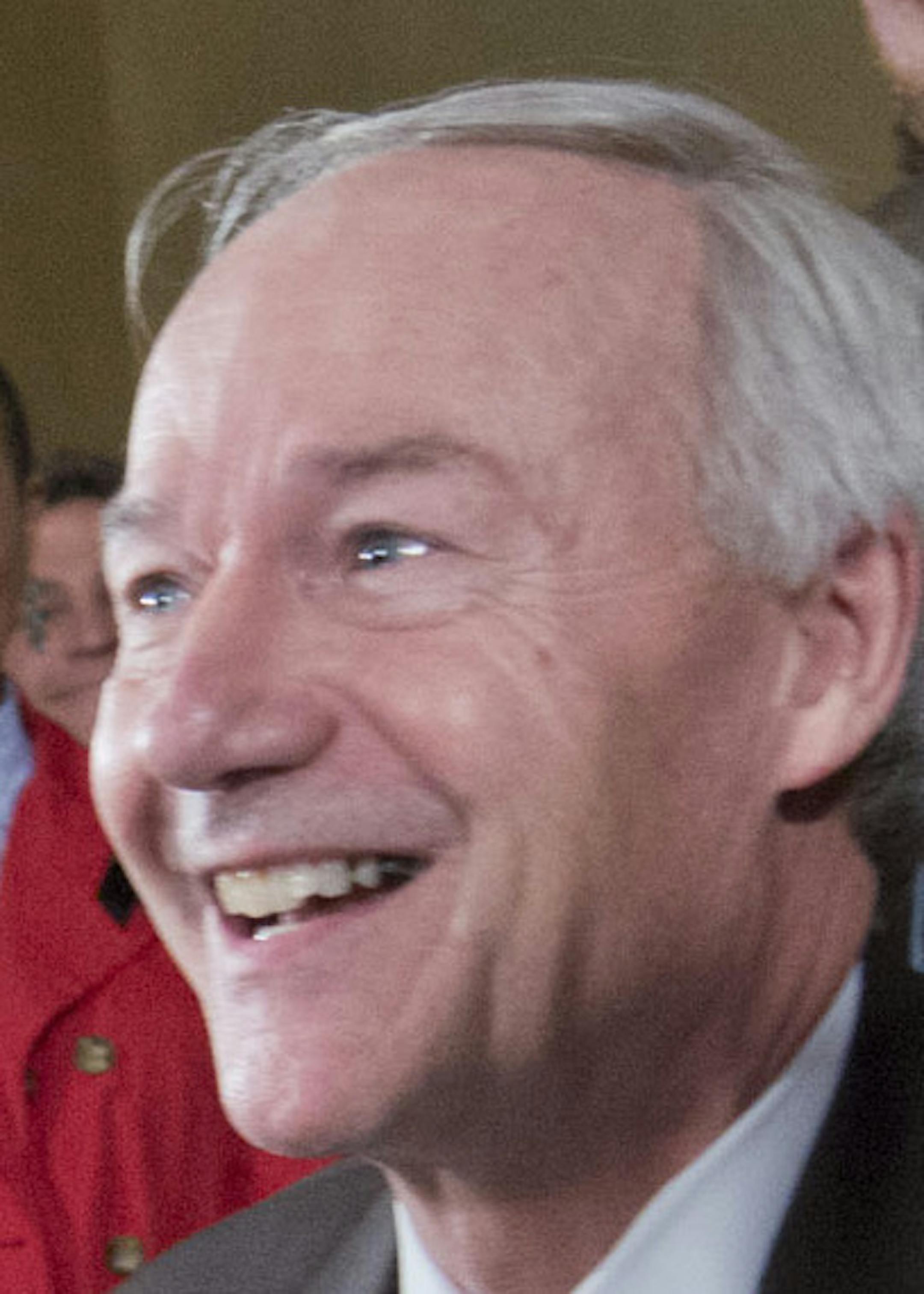 Arkansas Gov. Asa Hutchinson signs a reworked religious freedom bill into law after it passed in the House at the Arkansas state Capitol in Little Rock, Ark., Thursday, April 2, 2015. Lawmakers in Arkansas and Indiana passed legislation Thursday that they hoped would quiet the national uproar over new religious objections laws that opponents say are designed to offer a legal defense for anti-gay discrimination. (AP Photo/Brian Chilson)