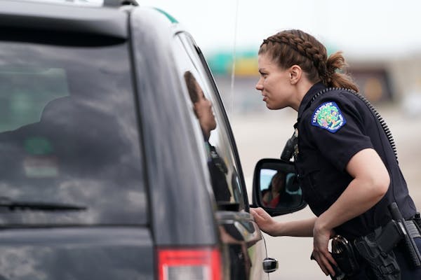 Eagan officer Kirsten Dorumsgaard talked with a motorist who was ticketed for typing on their phone.