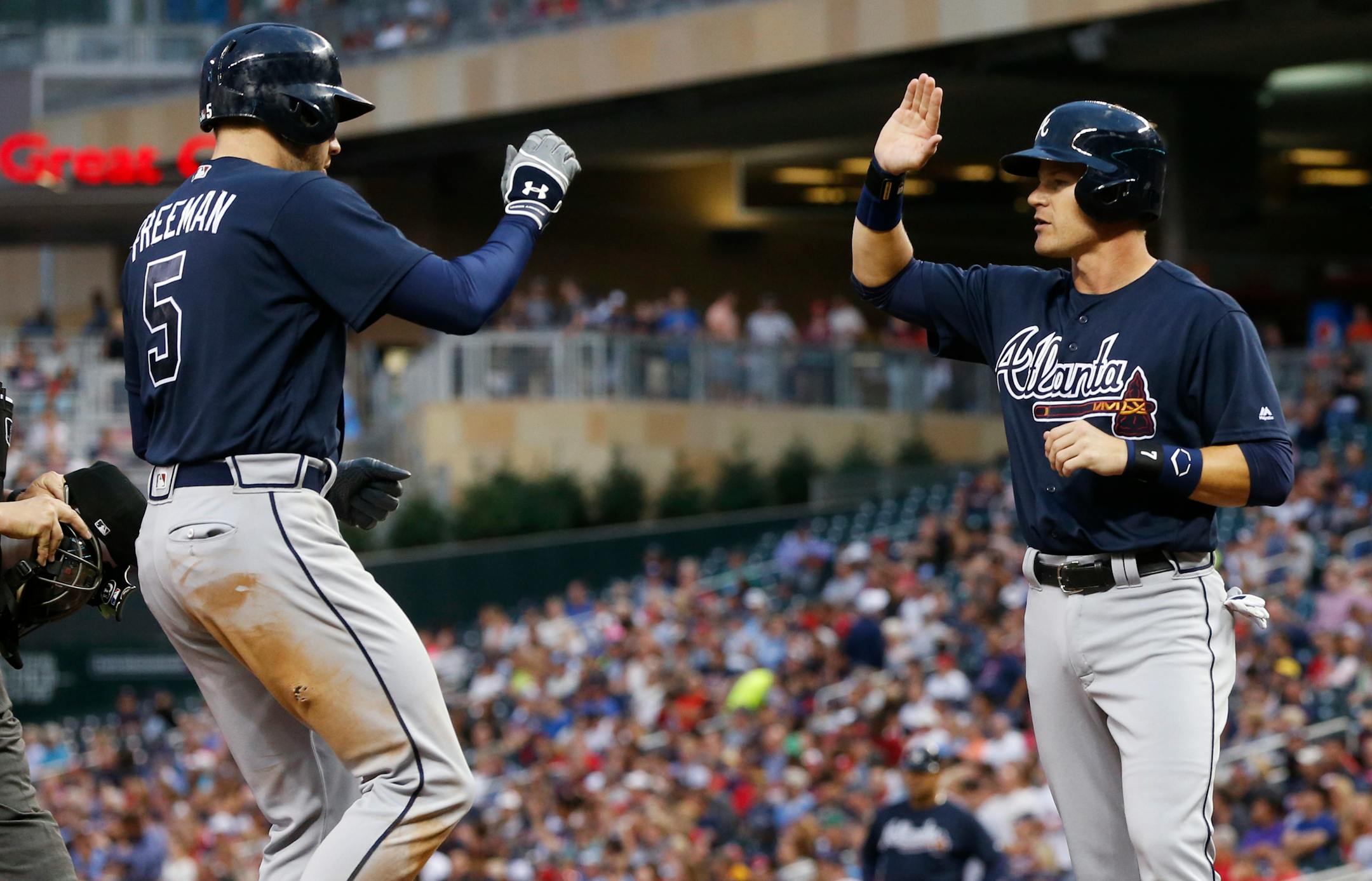 Atlanta Braves' Freddie Freeman, left, is congratulated by Gordon Beckham after Freeman's two-run home run off Minnesota Twins pitcher Michael Tonkin during the fourth inning of a baseball game Wednesday, July 27, 2016, in Minneapolis. (AP Photo/Jim Mone)