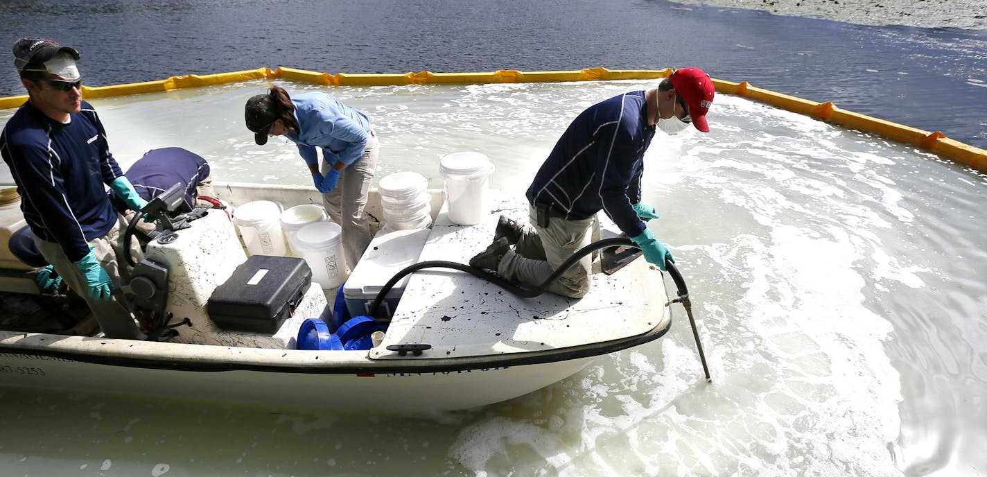 David Hillstrom treated an area on Christmas Lake for zebra mussels .Federal and state crews tested a product called Zequanox to try an control and infestation of zebra mussels on Christmas Lake Monday September 8 , 2014 in Shorewood, MN . A 50x60 feet section of the lake at the public access was treated . ] Jerry Holt Jerry.holt@startribune.com