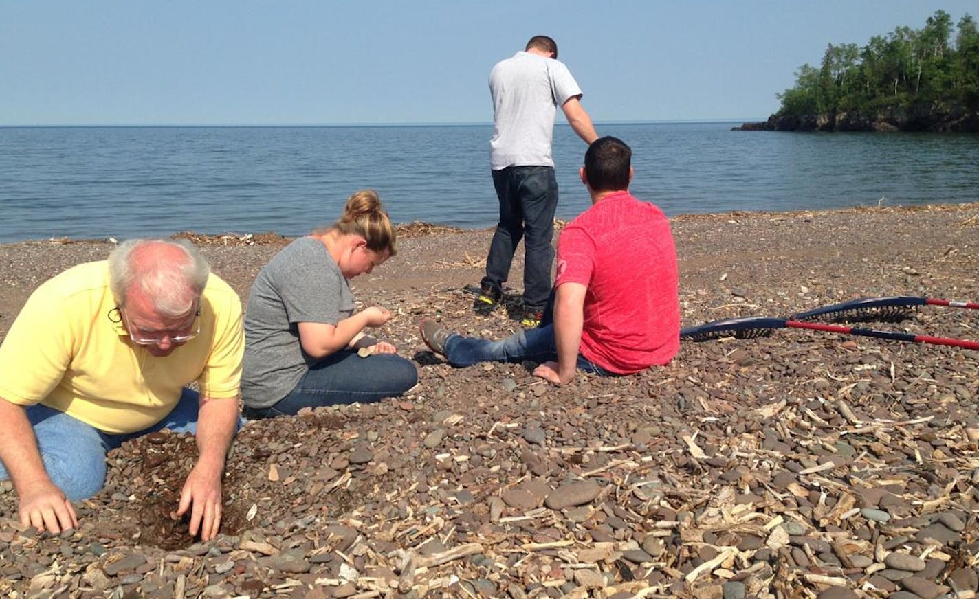 Mike Donovan, left, of St. Charles, Ill.; Megan Donovan of Stillwater, Okla.; Patrick Donovan of St. Charles, Minn.; and Justin Cobb of Stillwater look for agates at Superior Shores Resort near Two Harbors.