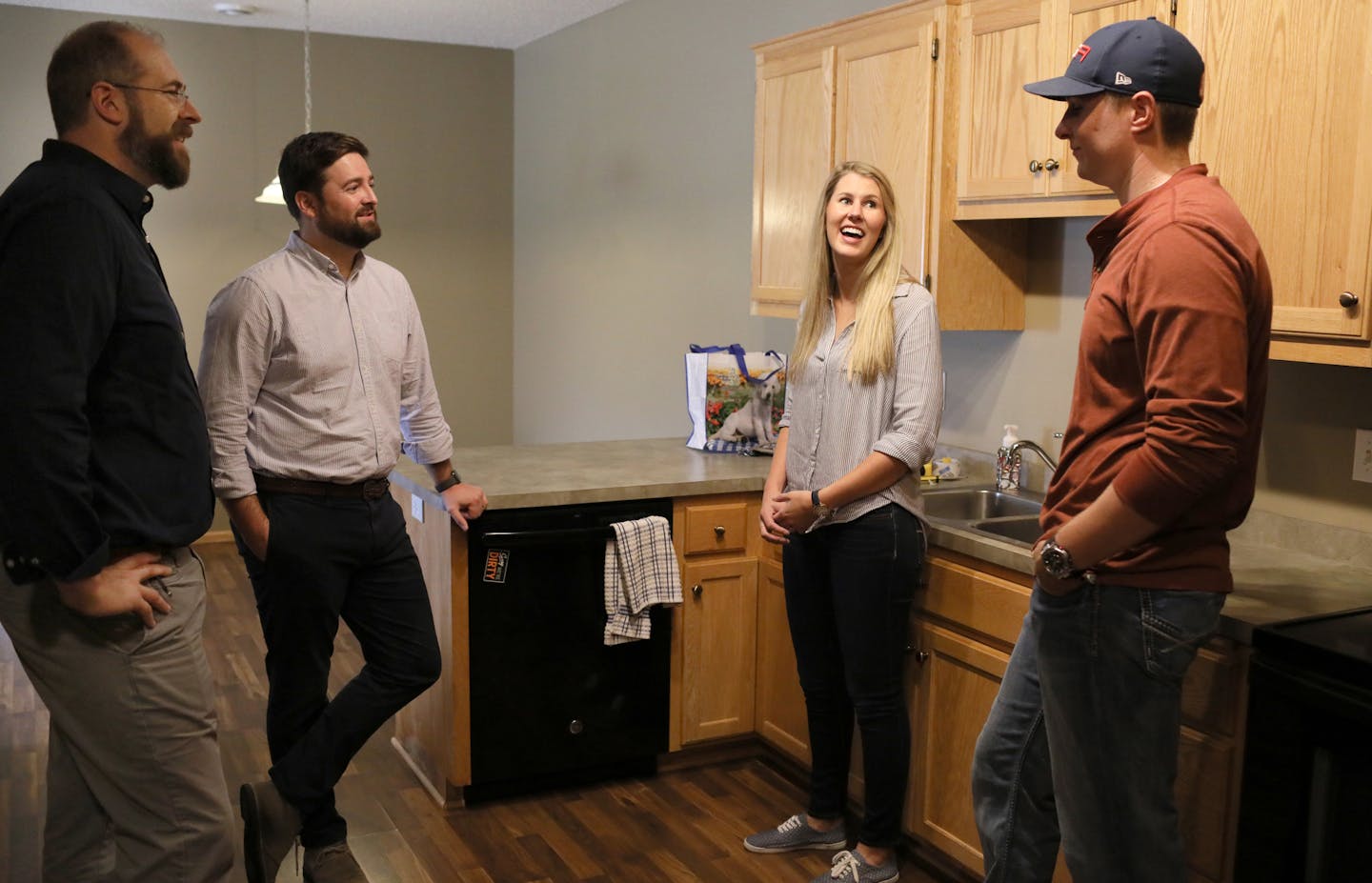 San Francisco-based Opendoor's Matt Bohlinger, head of homes, left to right, and P.J. O'Neil, Opendoor's Twin Cities general manager, chatted with home owners Laura and Jason and Riviere, at their home they were ready to sell Wednesday, Sept. 12, 2018, in Farmington, MN.] DAVID JOLES &#xef; david.joles@startribune.com A new real estate company wants to blow the doors off the traditional brokerage model in the Twin Cities. Literally. San Francisco-based Opendoor says that it wants to remove all t