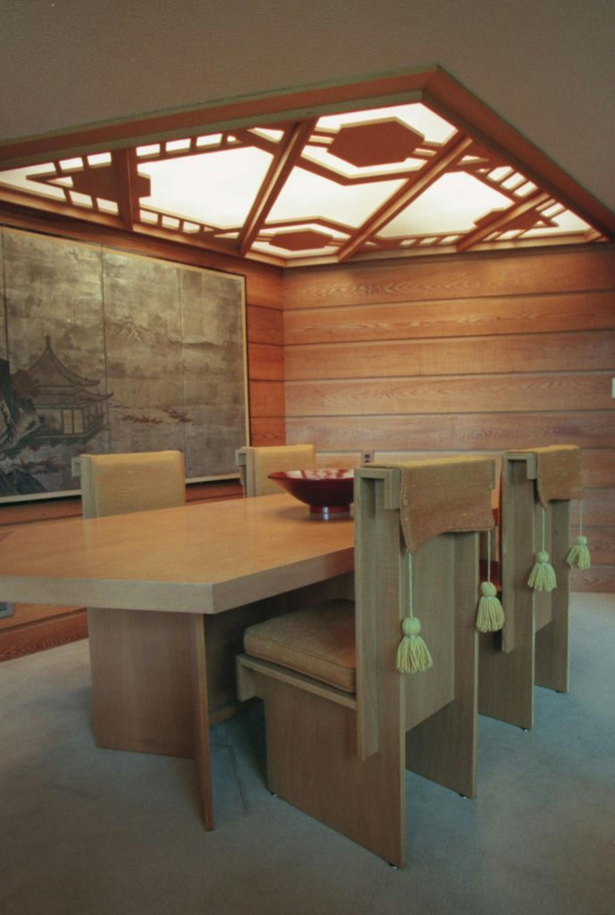 Dining room table and chairs, with overhead light fixture that uses a wood frame for the pattern and plastic sheets ( like those in office flouescent light fixtures) to diffuse the bulbs underneath.