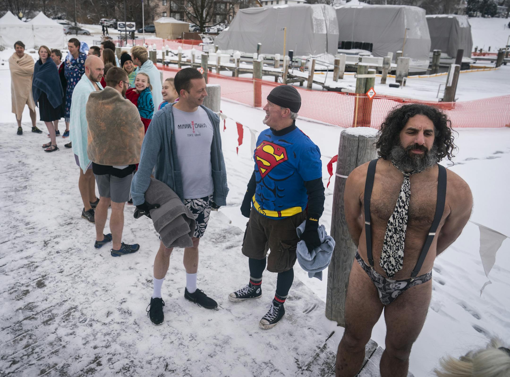 Duane Wirth, from right, of Minneapolis, Bill Hurley of St. Paul, and Rick Rindahl of Minneapolis waited in line to dive during the ALARC Ice Dive. ] LEILA NAVIDI • leila.navidi@startribune.com BACKGROUND INFORMATION: Divers participate in the 30th Anniversary ALARC Ice Dive on New Year's Day into Lake Minnetonka in Excelsior on Wednesday, January 1, 2020.