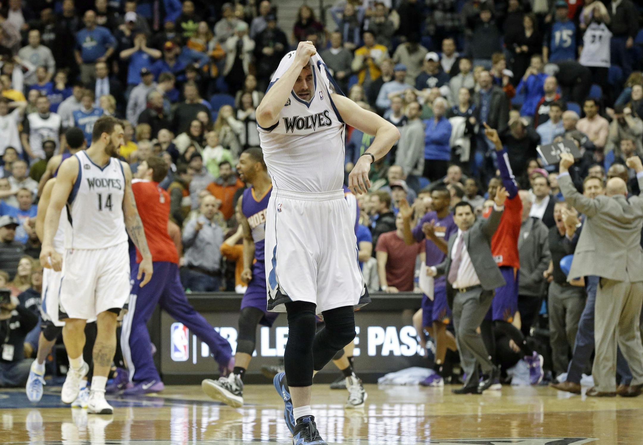 Minnesota Timberwolves' Kevin Love pulls his jersey over his head as he leaves the court after the Phoenix Suns came from behind to beat the Timberwolves 104-103 in an NBA basketball game Wednesday, Jan. 8, 2014, in Minneapolis. (AP Photo/Jim Mone)
