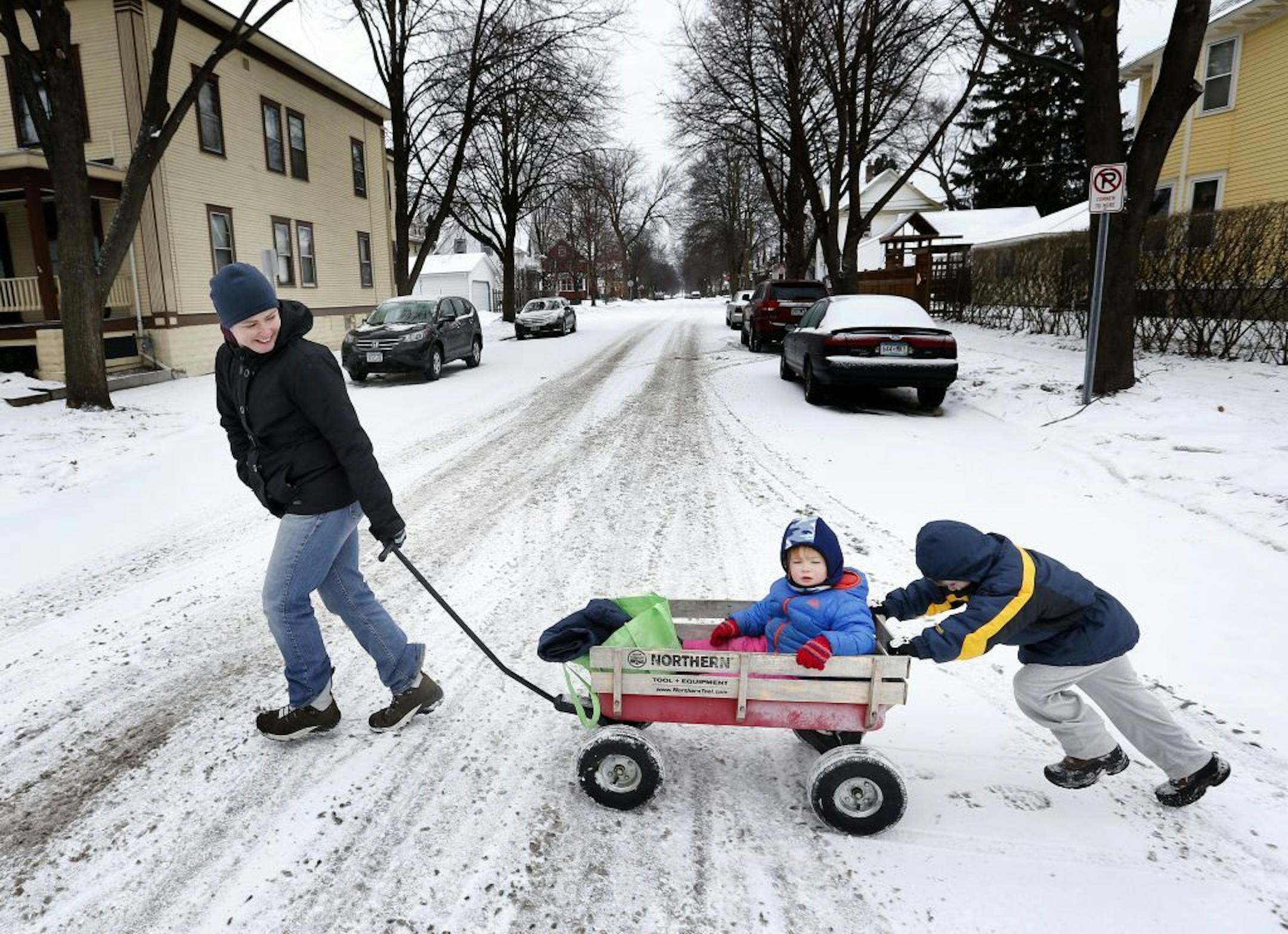 With Beatrice Power, 2, in the wagon Jennifer Power of St. Paul got helping hand crossing the street from her son Fritz, 5 on Tuesday afternoon. The family was walking home after picking up Fritz from his pre-K school.