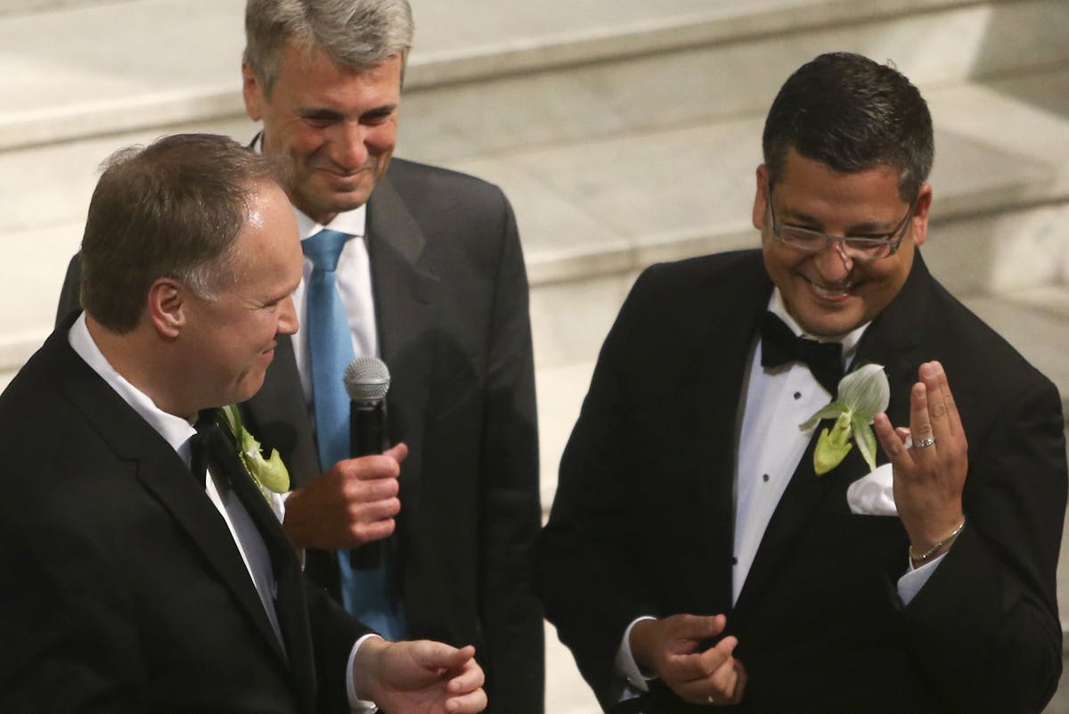 Al Giraud and Jeff Isaacson during their wedding ceremony at City Hall in Minneapolis.