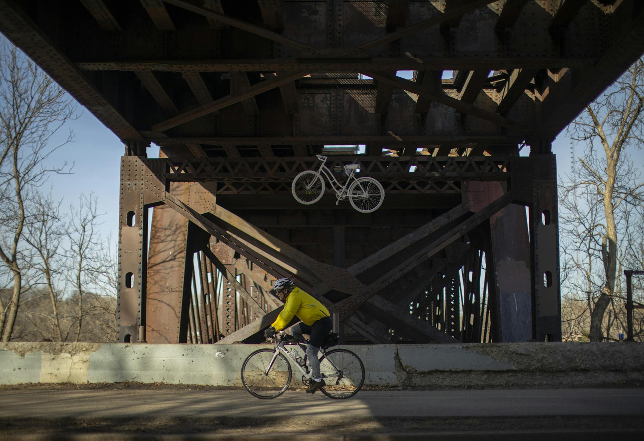 A cyclist on the West River Parkway bike path rode beneath the Short Line bridge Wednesday afternoon. ] JEFF WHEELER ï jeff.wheeler@startribune.com There are discussions taking place about exploring whether the CM & StP Railroad's Short Line bridge over the Mississippi River at the Midtown Greenway could be overhauled for bike and pedestrian use. The Greenway / railroad corridor was photographed Wednesday afternoon, April 25, 2018 in Minneapolis.