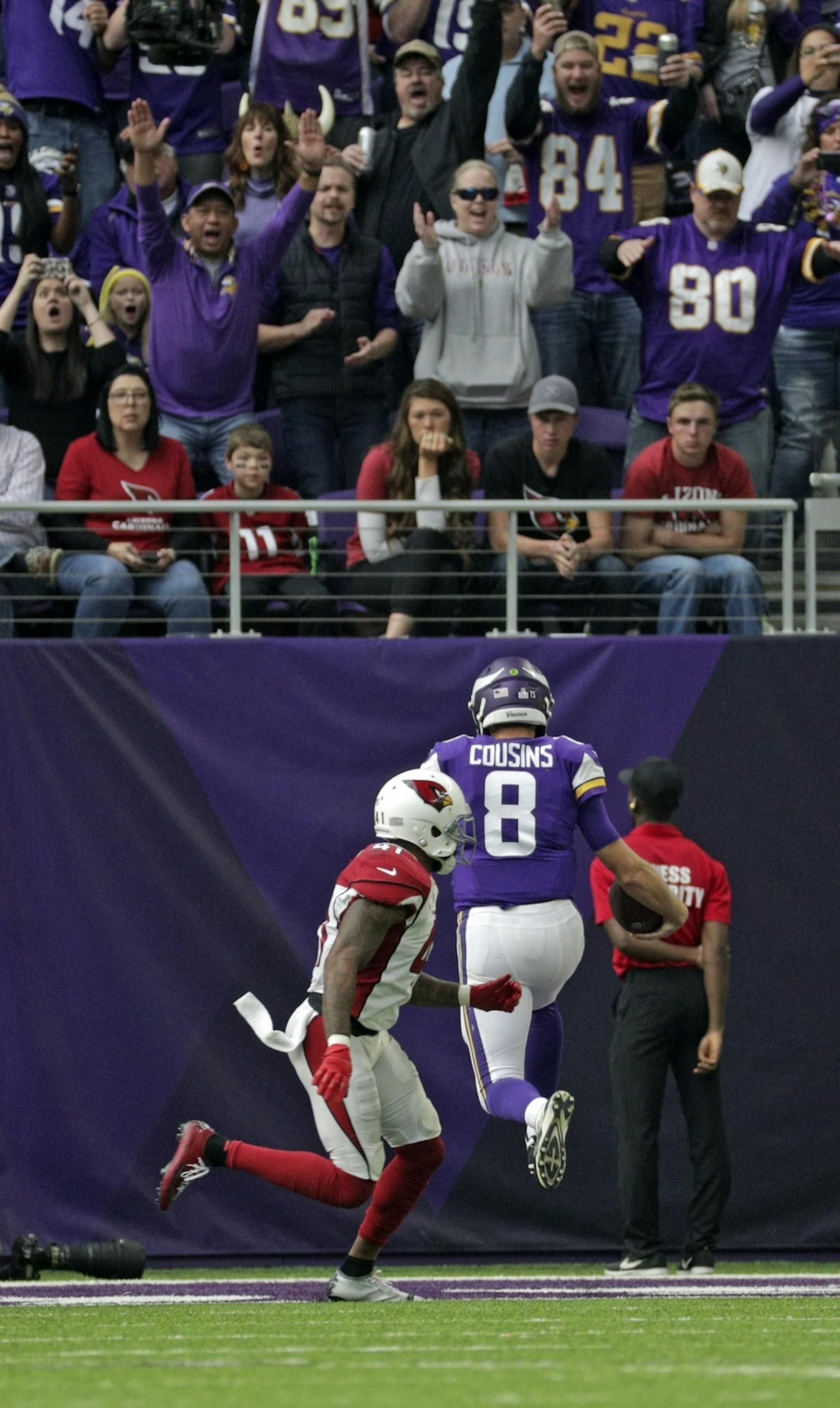 Vikings quarterback scored his first TD as a Viking in the 3rd Quarter. Arizona fans in the front row were not too happy.