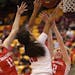 Angel McClain(20) of Red Lake is defended by Teana Hakamaki(11) and Bailey Gronner(12).